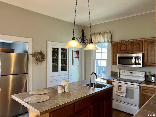 102 W Lorton St, Roodhouse, IL 62082 - kitchen with stainless steel appliances, a sink, pendant lighting, ornamental molding, and brown cabinetry