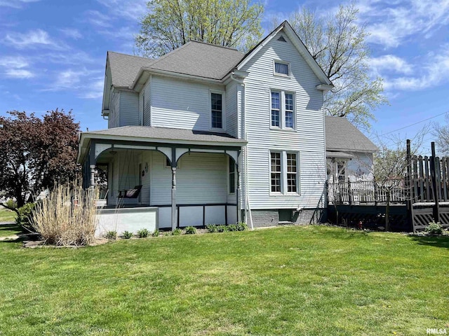102 W Lorton St, Roodhouse, IL 62082 - rear view of house with a lawn, roof with shingles, and a porch