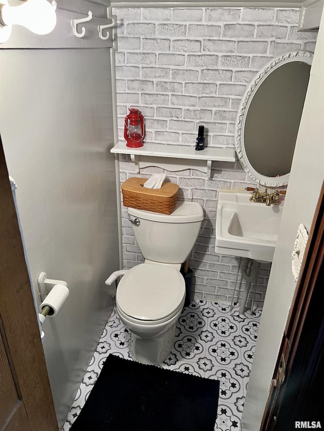 102 W Lorton St, Roodhouse, IL 62082 - half bathroom featuring a sink, toilet, and tile patterned flooring