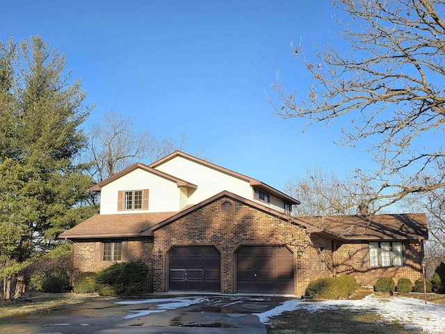 view of front of home with brick siding, driveway, and an attached garage