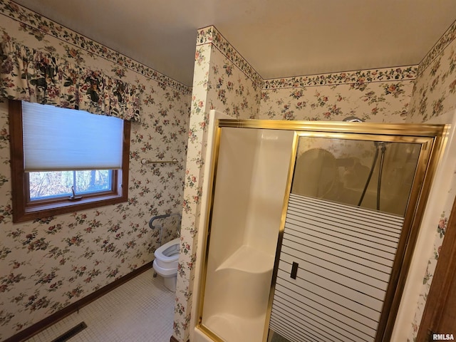 bathroom featuring baseboards, tile patterned floors, a shower stall, and wallpapered walls