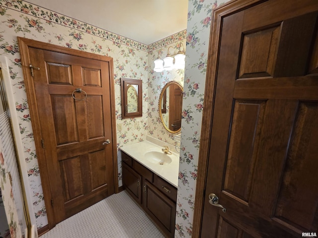 bathroom with wallpapered walls and vanity