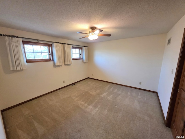 unfurnished bedroom featuring light carpet, visible vents, baseboards, and a textured ceiling