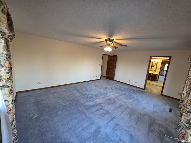 unfurnished bedroom with a textured ceiling, ceiling fan, carpet, and baseboards