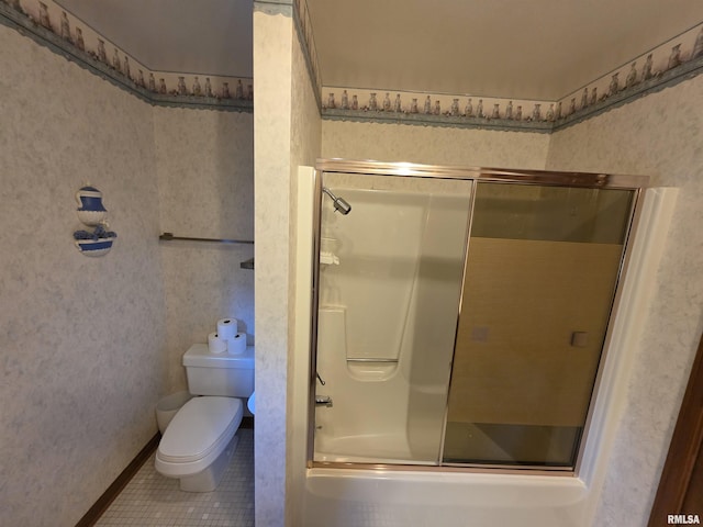 bathroom featuring tile patterned flooring, a shower with shower door, toilet, and wallpapered walls