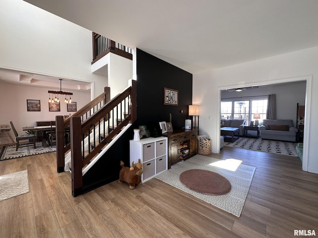 interior space featuring a chandelier, stairway, and light wood-style floors