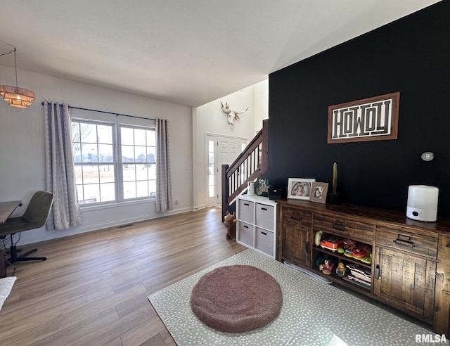 interior space featuring baseboards, visible vents, and wood finished floors