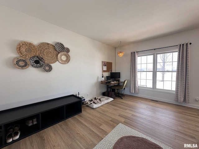 office area featuring wood finished floors, visible vents, and baseboards