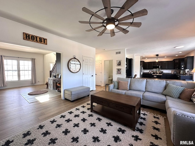 living area featuring ceiling fan, light wood-style flooring, recessed lighting, visible vents, and baseboards