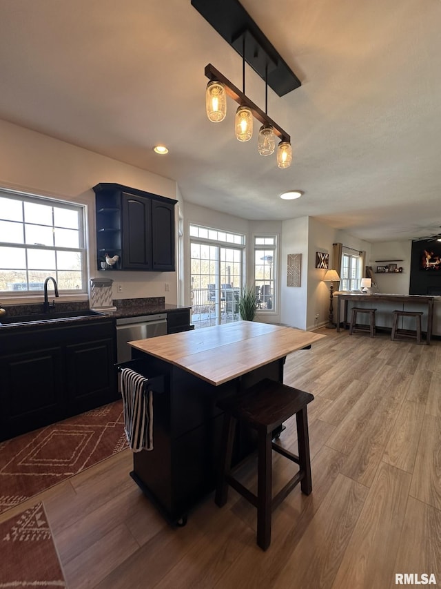 dining area featuring light wood-style floors, plenty of natural light, and recessed lighting