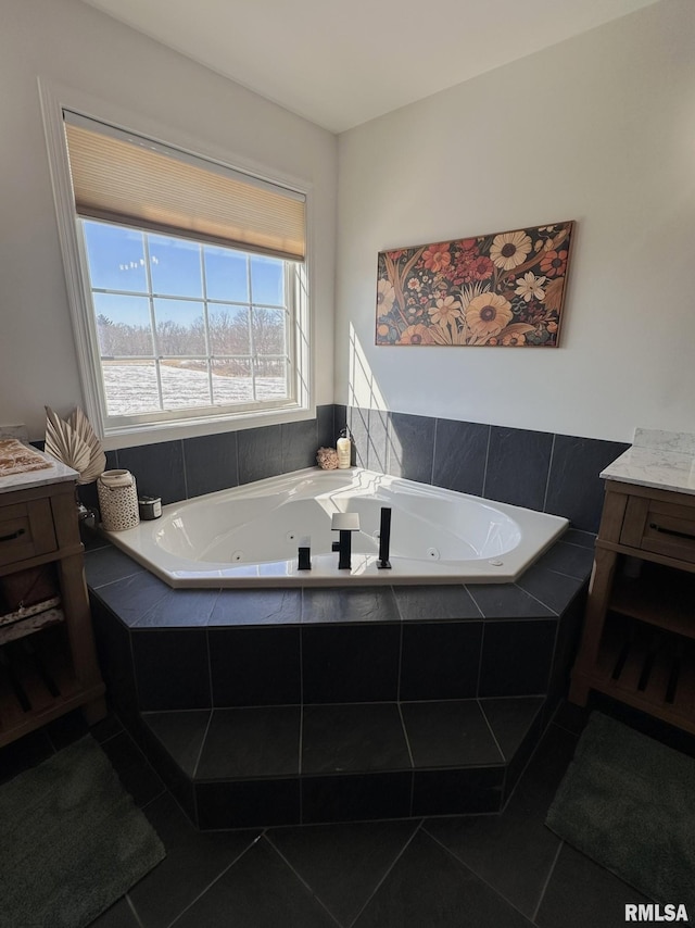 bathroom with a whirlpool tub, tile patterned flooring, and vanity