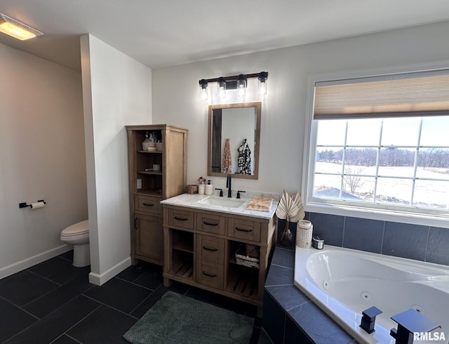 full bathroom with baseboards, toilet, a whirlpool tub, tile patterned flooring, and vanity