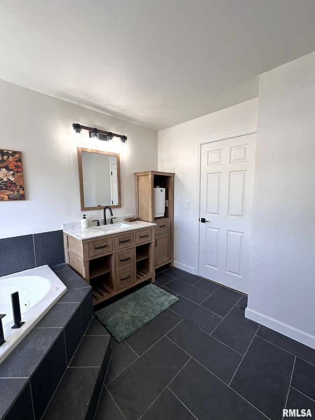 bathroom featuring a jetted tub, tile patterned flooring, vanity, and baseboards