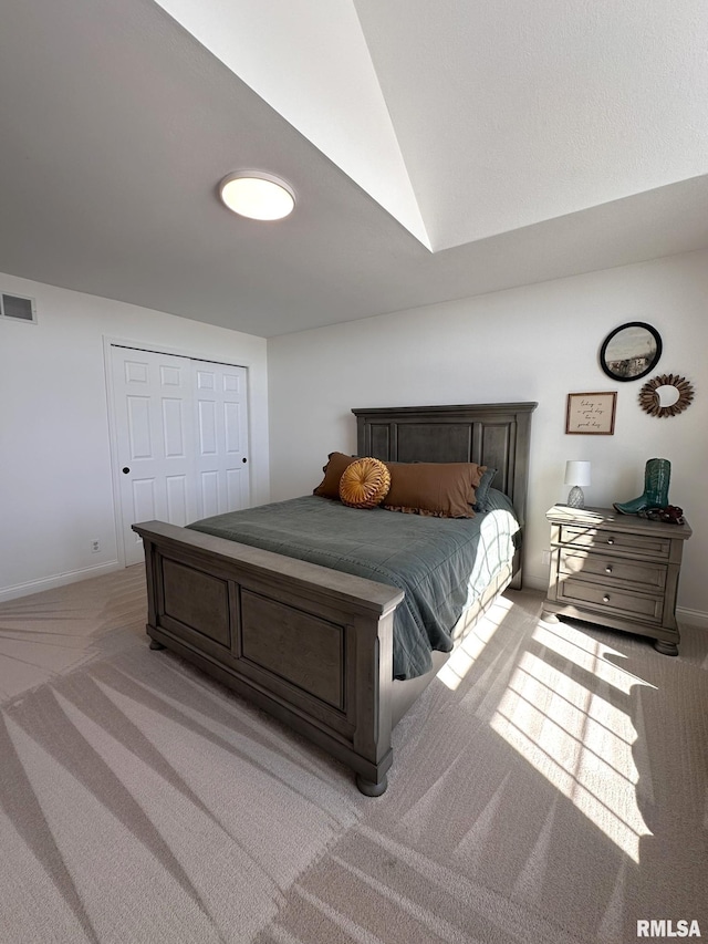 bedroom featuring light colored carpet, visible vents, vaulted ceiling, and baseboards