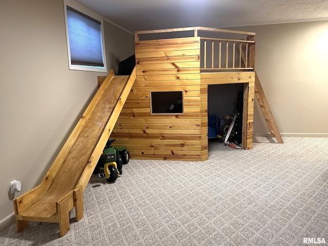 interior space with carpet floors, baseboards, and crown molding