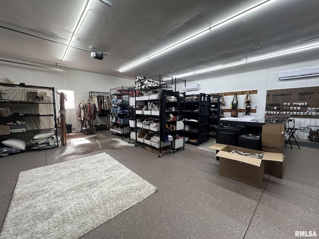 garage featuring a wall mounted AC, a workshop area, and a garage door opener