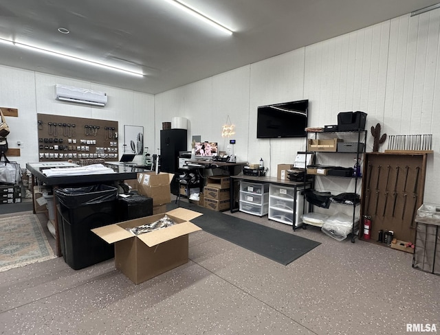 miscellaneous room featuring speckled floor and a wall mounted AC