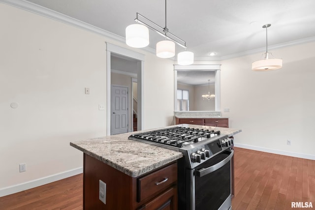 kitchen featuring ornamental molding, stainless steel range with gas stovetop, and dark wood finished floors