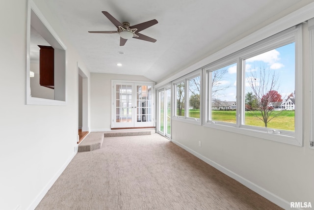 unfurnished sunroom with vaulted ceiling and a ceiling fan