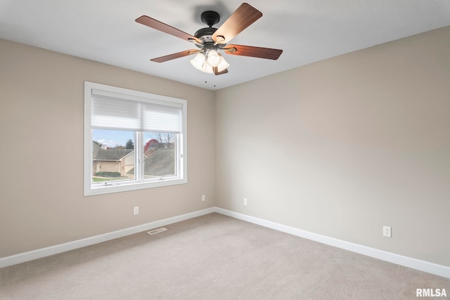 spare room with visible vents, light carpet, and baseboards