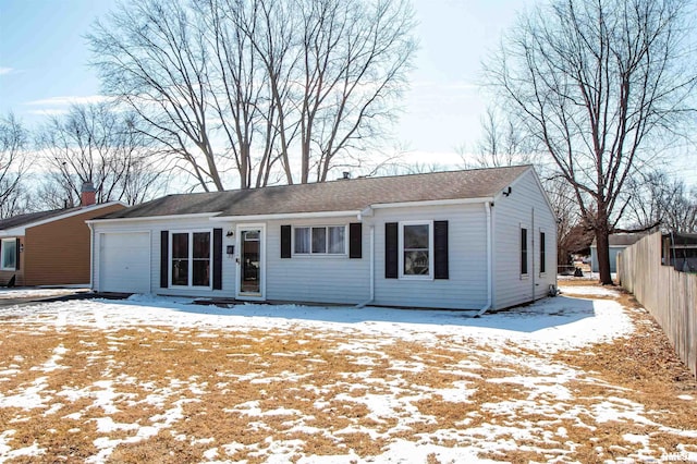 single story home featuring a garage and fence