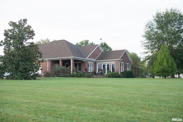 ranch-style home featuring a front yard and brick siding