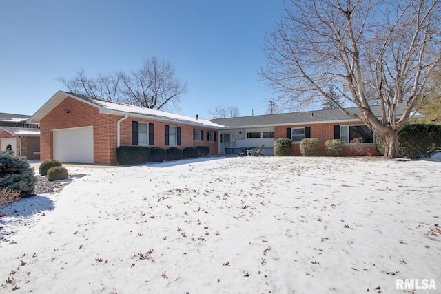 single story home with brick siding and an attached garage