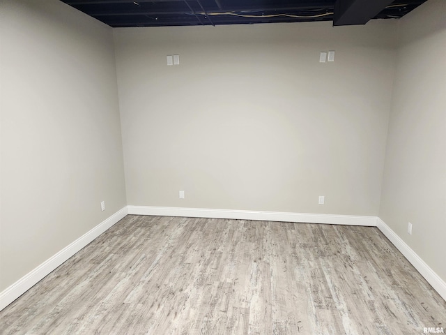 finished basement featuring baseboards and wood finished floors
