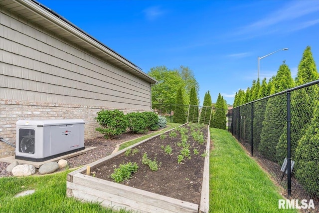 view of yard with fence and a garden