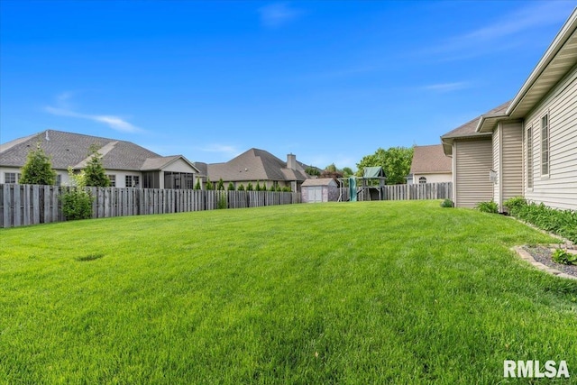 view of yard featuring fence and a residential view