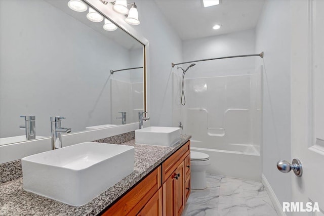 bathroom featuring a sink, toilet, double vanity, and marble finish floor