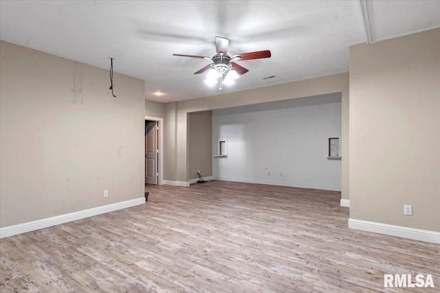 unfurnished room with baseboards, ceiling fan, and wood finished floors
