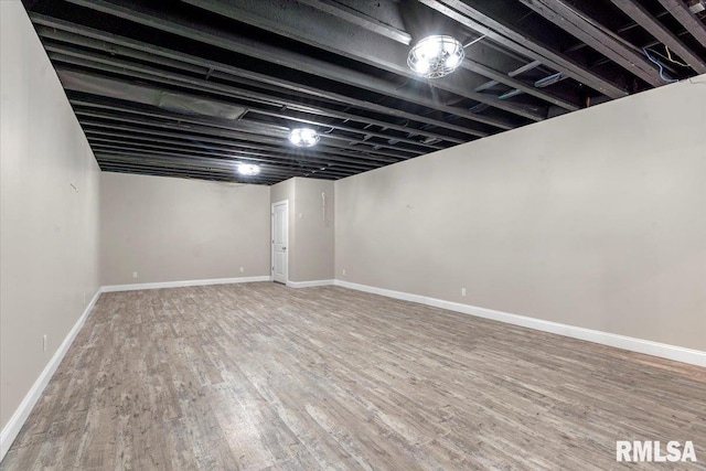 finished basement with baseboards and wood finished floors