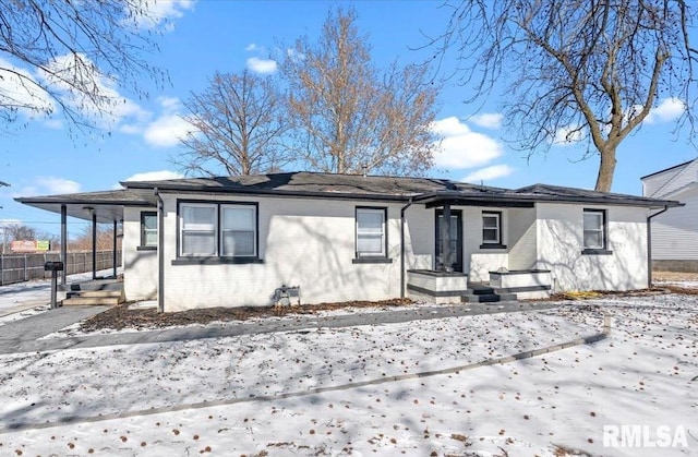 view of front of house featuring an attached carport and brick siding