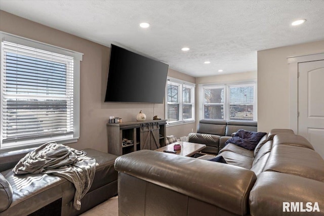 living room featuring a textured ceiling and recessed lighting