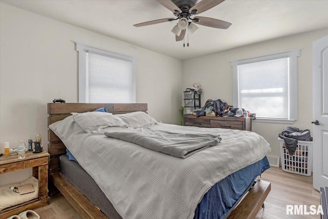 bedroom with light wood-type flooring and a ceiling fan