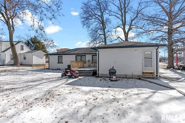 view of snow covered rear of property