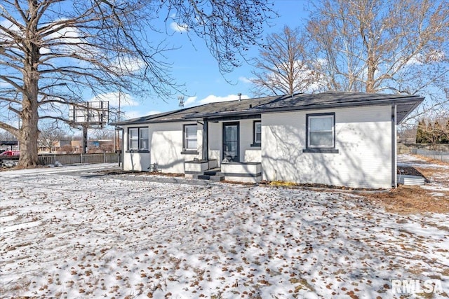 single story home featuring brick siding and fence