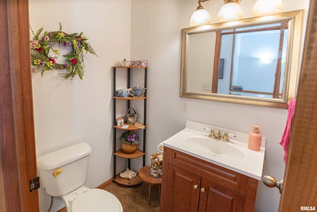 bathroom featuring toilet and vanity