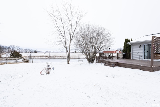 snowy yard with a deck