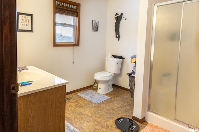 full bathroom with toilet, a stall shower, vanity, and baseboards