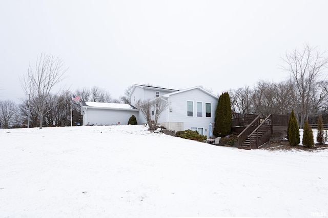 view of front of home featuring a garage, a deck, and stairway