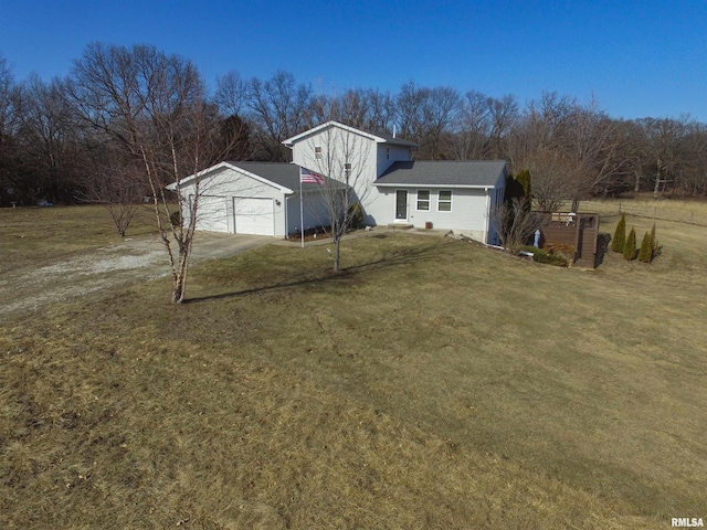 view of front of home featuring driveway, a garage, and a front yard