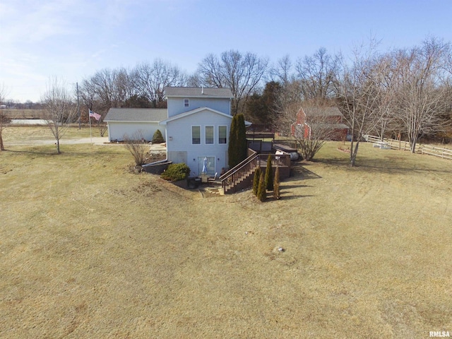 exterior space with a rural view, a lawn, and stairway