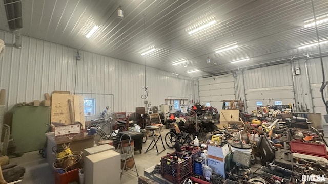 garage featuring metal wall and a workshop area