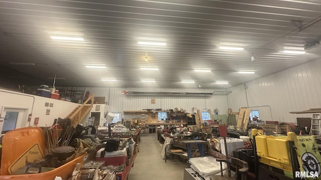 garage featuring a workshop area and metal wall