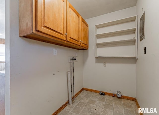 washroom featuring cabinet space, hookup for a washing machine, and baseboards