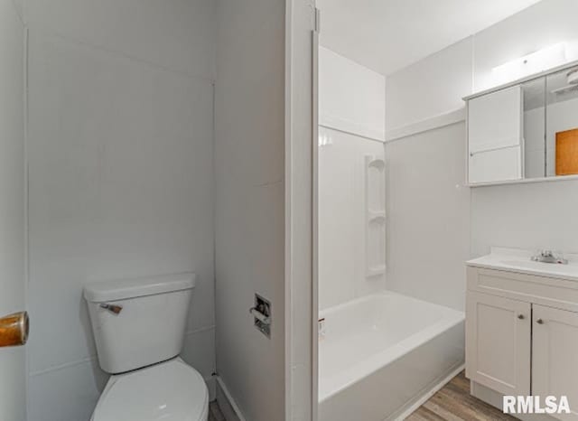 bathroom with toilet, shower / bathtub combination, wood finished floors, and vanity