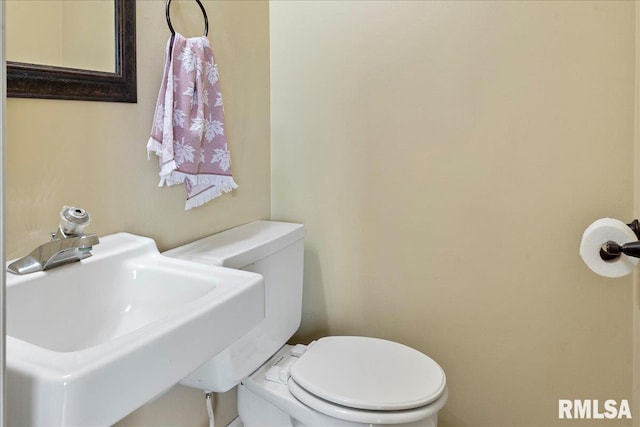 bathroom with toilet and a sink