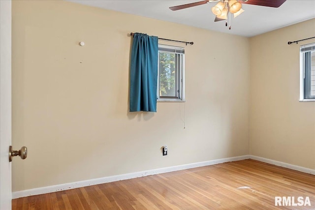 unfurnished room with a ceiling fan, light wood-style flooring, and baseboards